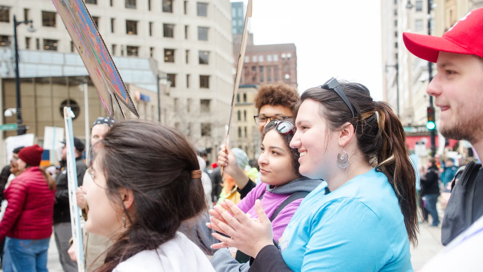 Young Wisconsinites gather with handmade signs at a Milwaukee rally.